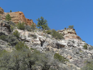 Colorful cliffs of pyroclastic white to reddish rhyolite semi-welded ash fall tuffs overlying andesite flow rocks.