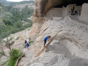 climbing the ladder at Gila Cliff Dwellings.